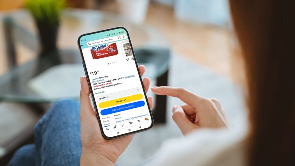 A person holding phone with Amazon app open